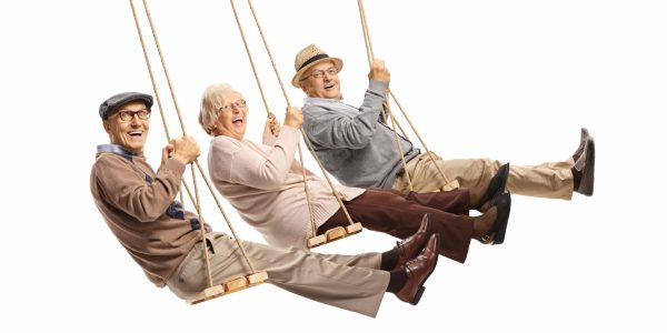 Happy senior people swinging on swings isolated on white background