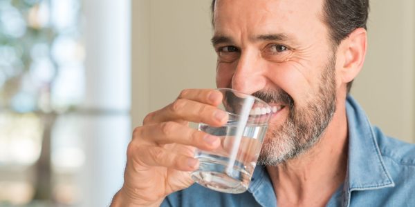 Middle,Age,Man,Drinking,A,Glass,Of,Water,With,A