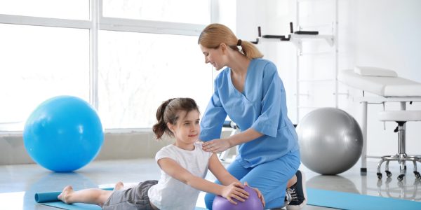 Physiotherapist,Working,With,Little,Girl,In,Rehabilitation,Center