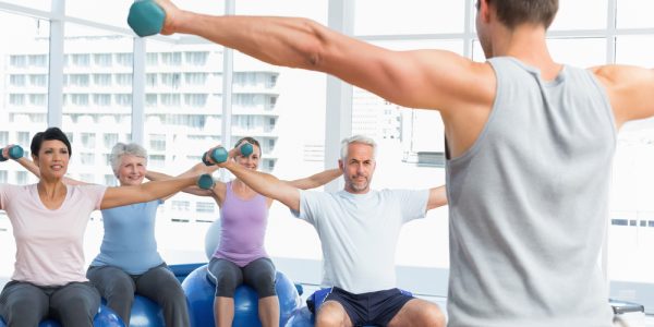 Portrait,Of,Fitness,Class,With,Dumbbells,Sitting,On,Exercise,Balls