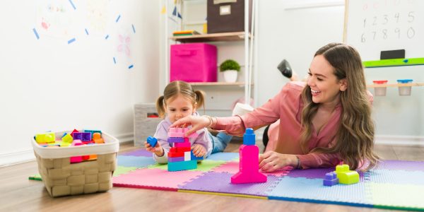 Happy,Girl,And,Female,Therapist,Playing,With,Building,Blocks,And