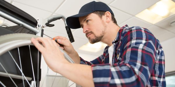 Man,Working,In,Wheelchair,Repair,Shop