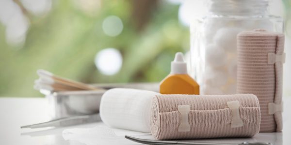 Bandage,And,First,Aid,Kit,On,White,Table,,Bokeh,Background.