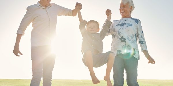 Family,,Holding,Hands,And,Grandparents,With,Boy,In,Park,,Nature