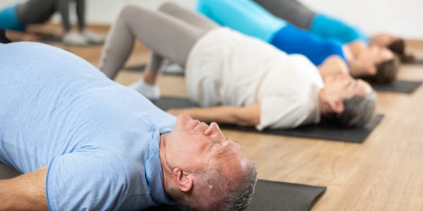 People,Of,Different,Ages,Performing,Glute,Bridge,During,Group,Pilates