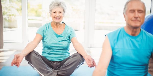 Portrait,Of,Happy,Senior,Woman,With,Husband,Meditating,At,Home