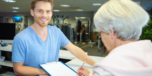 Elderly,Woman,Registering,At,Fitness,Center