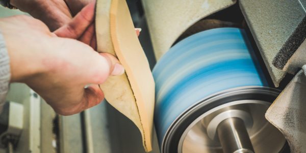 Adjusting,An,Orthotics,Sole,By,Sanding,It,In,A,Workshop